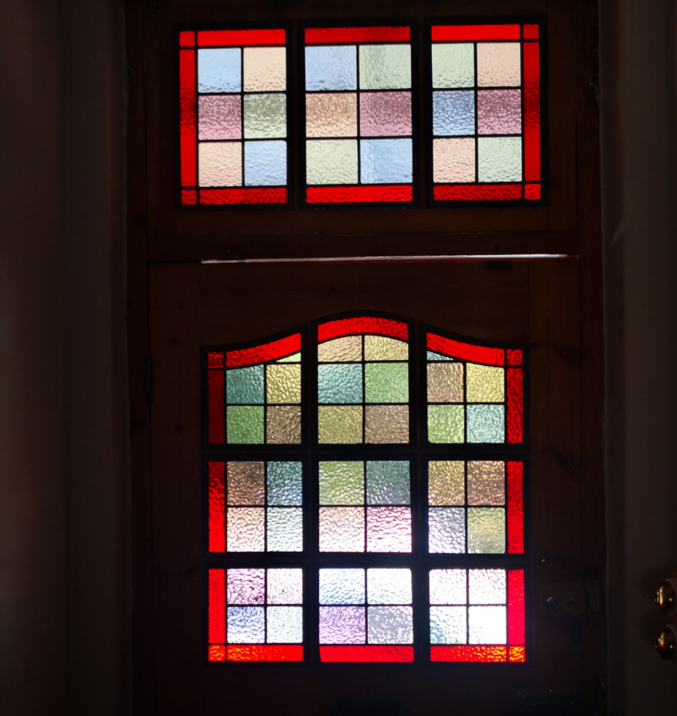 pastel blocks with red border stained glass window for front door