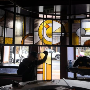 Installing art deco stained glass panels at Egghead Diner for bulkhead