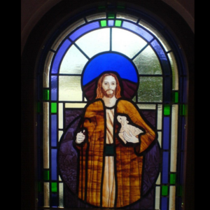 Painted stained glass window, depiting Jesus as the Lamb, designed by Vicki crowley