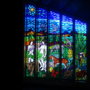 painted stained glass window about the garden of eden, designed by Vicki crowley