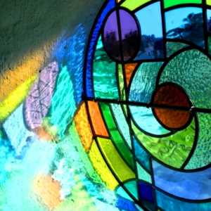 colorful round stained glass window with refelections